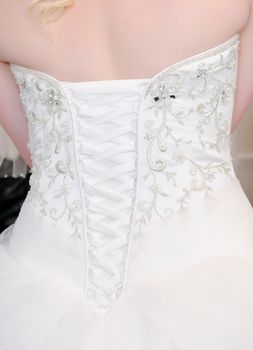 Brides white dress closeup back, showing detail on wedding day
