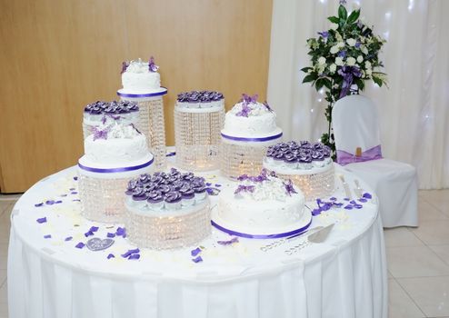 Big white and purple asian wedding cake at reception