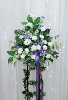 White and purple flower bouquet decorates wedding reception