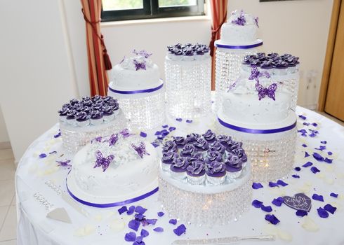 Massive white and purple asian wedding cake at reception