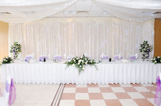 Wedding reception table with decoration of white flowers