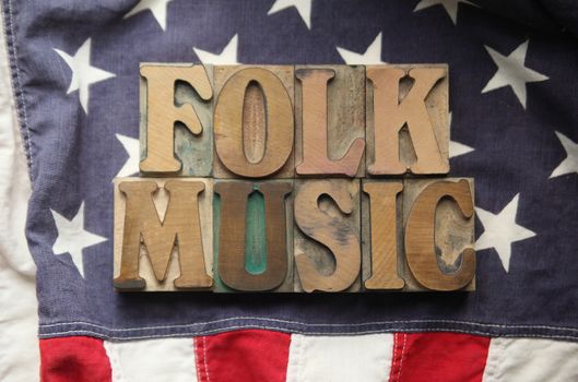 an American flag with the words folk music in old wood type