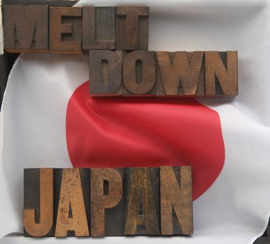 the words Japan and meltdown in old wood type on a Japanese flag