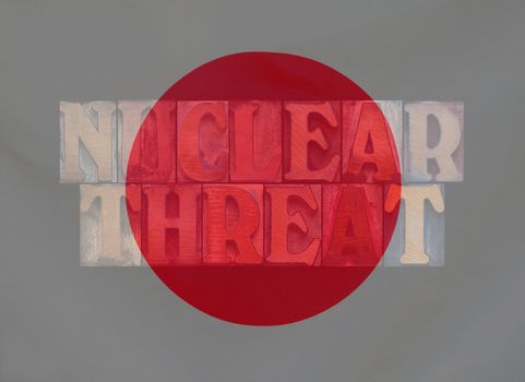 the words nuclear threat layered with the Japanese flag