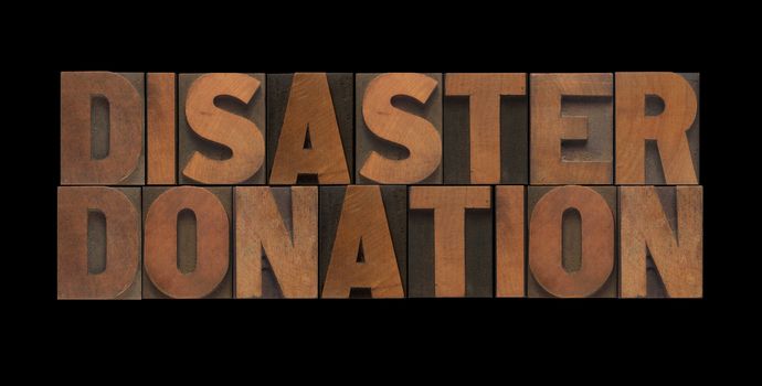 the words disaster donation in old wood type