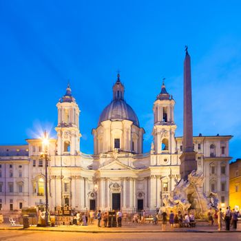 Fountain of the four Rivers and SantAgnese in Agone on Navona square in Rome, Italy, Europe shot at dusk.