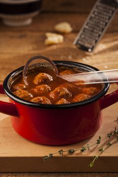 Meatballs in red pan with tomato sauce