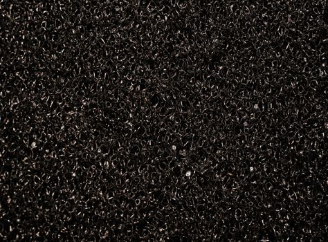 Texture black synthetic porous sponges as background                               