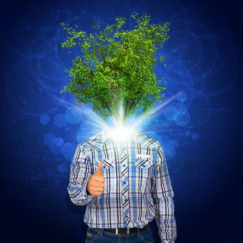 Man stand with green tree and bright light instead his head. Eco concept