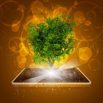 Tablet pc with magical green tree and rays of light on dark background