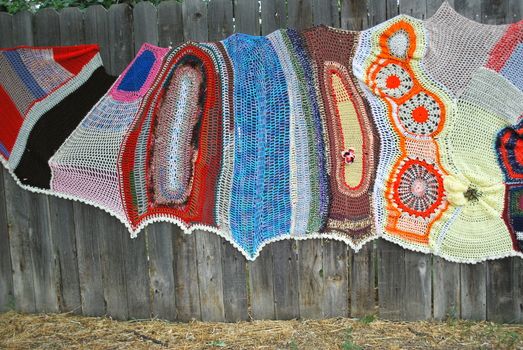 Crochet designs displayed outdoors.