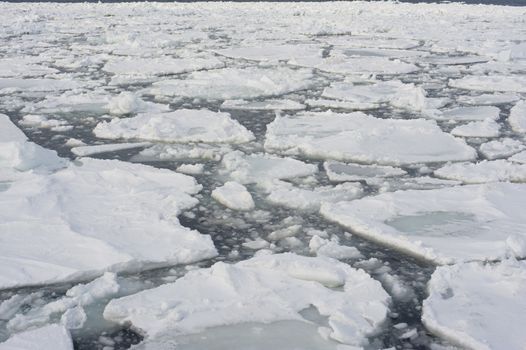 Drift ice in Abashini, Japan which has broken away from the shore or glaciers in small floes which can be driven into a dense mass by the wind to form pack ice , as viewed from the Aurora icebreaker