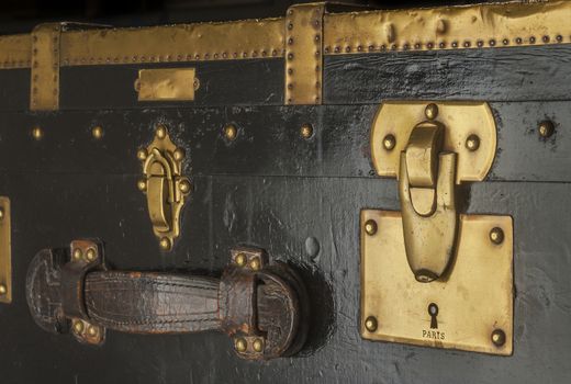 Antique steamer trunk lock and latches in brass, leather and wood custom made in Paris before WWII Antique steamer trunk lock and latches in brass, leather and wood custom made in Paris before WWII, isolated
