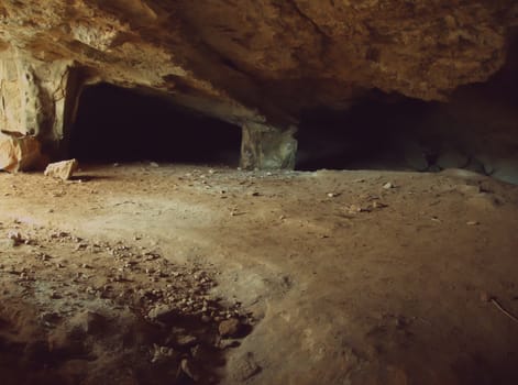 Underground cave entrance and tunnel with sunbeam end shadows