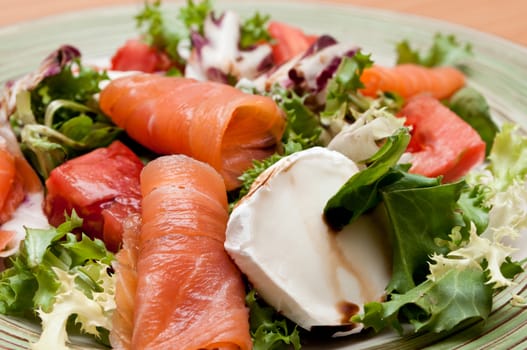 salad with tomatoes, goat cheese and salmon