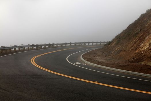 Autumn road and fog. Twin Peaks Mountain is the highest point in San Francisco, CA