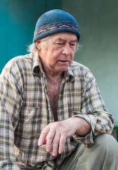 Seniors portrait of contemplative old caucasian man looking down. 