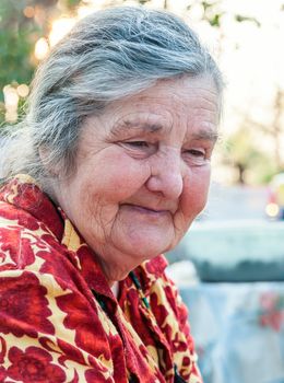 Senior woman on the background of his home