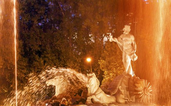 Neptune with Trident Snake in Chariot, Roman God, Statue Fountain Fuento de Neptuno Night Plaza Canovas del Castillo Madrid Spain.  Neptune Statue designed in 1780 by Ventura Rodriguez as part of Carolos III's scheme to beautify Madrid, Spain.