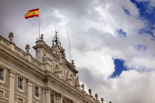 Royal Palace Palacio Real Clouds Sky Cityscape Spanish Flag Madrid Spain.  Phillip 5 rreconstructed palace in the 1700s.