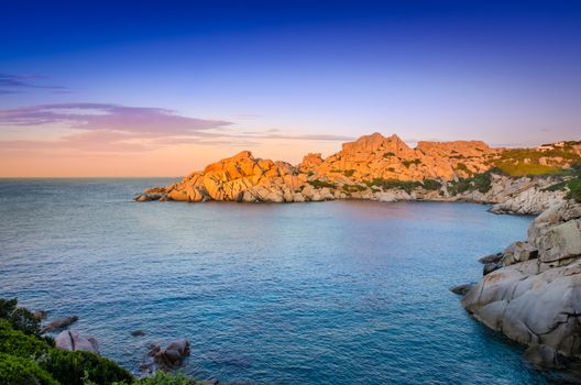 Ocean rocky coastline colorful sunset view, Sardinia, Italy