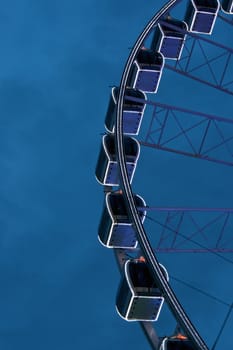 Giant swing is big wheel retro on blue sky background.