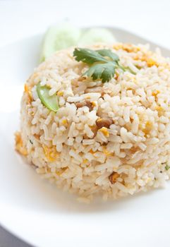 fried rice with pork and cucumber garnish in Asia