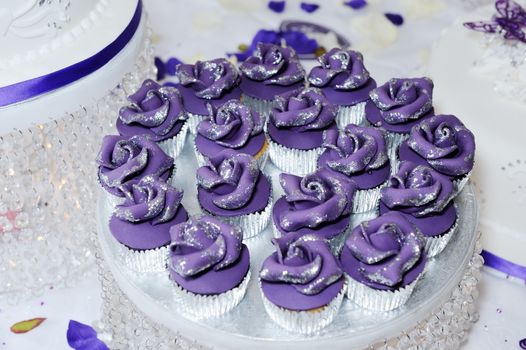 Purple or violet cup cakes at wedding reception closeup detail