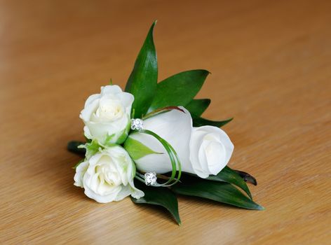 Mothers corsage is white rose on wedding day