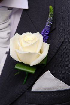 Grooms buttonhole flower at wedding