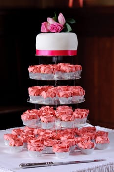 Pink cup cakes at a wedding reception