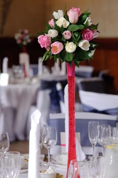 Wedding flowers on red stand at the reception