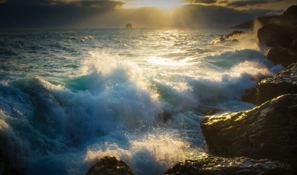 The sea breaks against the rocks