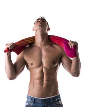 Hunky male model drying himself with a red towel on white background