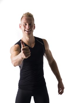 Fit male model with a big smile giving a thumbs up on white background