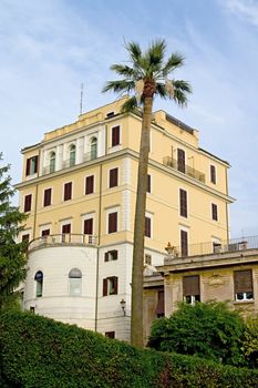 Photo shows Rome cityscape with houses and roofs.