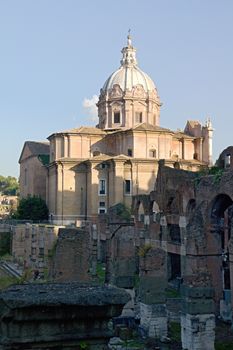 Photo shows Rome cityscape with houses and roofs.