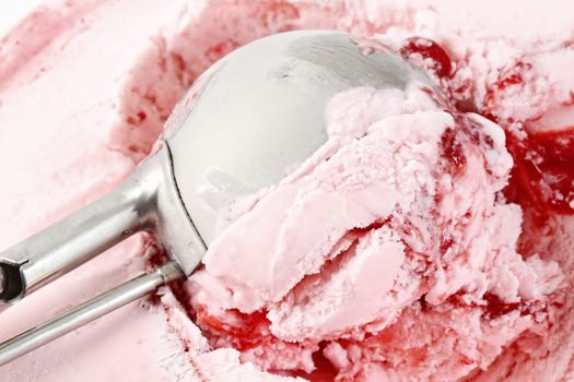 Scoop of strawberry ice cream from container 