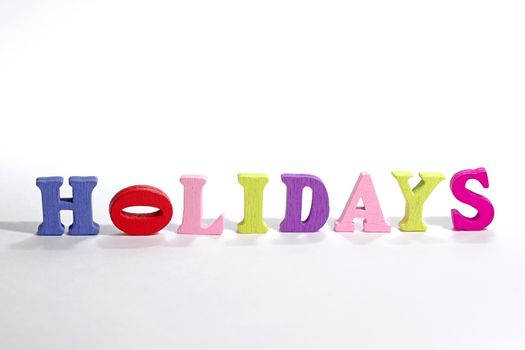 Photo shows detail of holidays sign on white background.