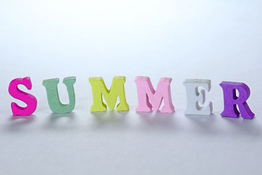 Photo shows detail of summer sign on white background.