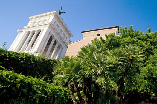 Photo shows Rome cityscape with houses and roofs.