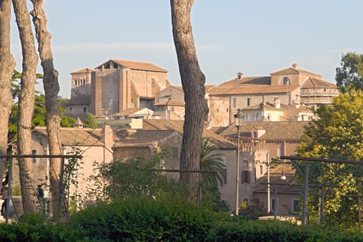 Photo shows Rome cityscape with houses and roofs.