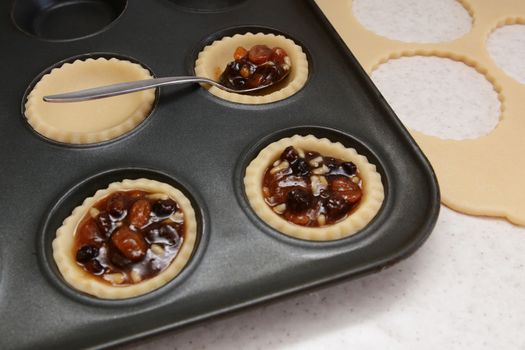Filling mince pies with mincemeat, pastry scraps beyond