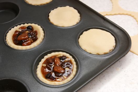 Mince pies being made - open and finished with plain pastry lids