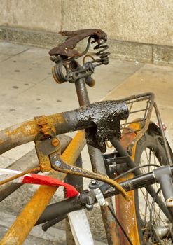 Close up on saddle of burnt bicycle in the street