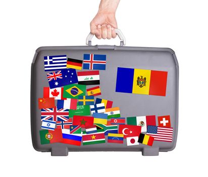 Used plastic suitcase with lots of small stickers, large sticker of Moldova