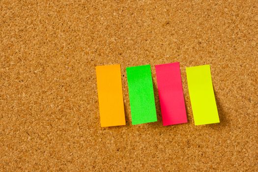 image of color blank post-it reminder on corkboard