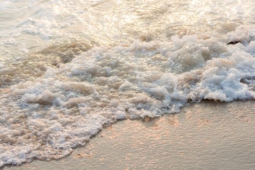 Wave of the sea sunset on sand beach