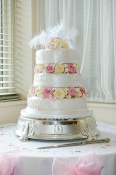 Wedding cake by window at reception
