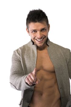 Confident, smiling young man with open sweater on muscular torso, ripped abs and pecs, pointing finger to camera